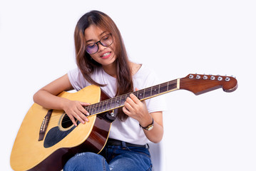 Fototapeta premium Woman Asian playing a acoustic guitar isolated on white background. selective focus