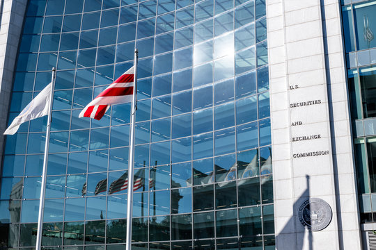 Washington DC, USA - October 12, 2018: United States Securities And Exchange Commission SEC Architecture Closeup With Modern Building Sign And Logo With Red Flags By Glass Windows