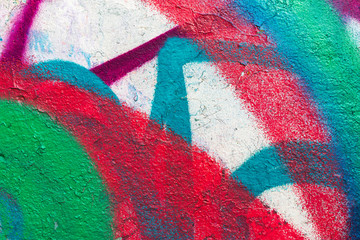 Multi-colored concrete wall with graffiti