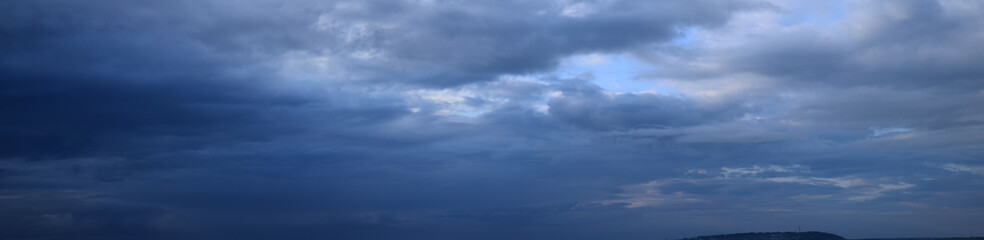 Big summer clouds. Atmospheric phenomenon - the vapor state of water. Panoramic photo