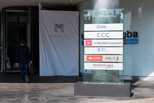 Warsaw, Poland - August 23, 2018: Exterior of Metropolitan modern business center with sign for companies such as Gide, CCC and Mitsubishi corporation