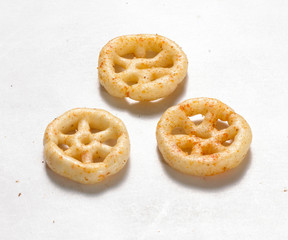 Fried and Spicy wheel Snacks or Fryums (Snacks Pellets) served in a White background. selective focus - Image