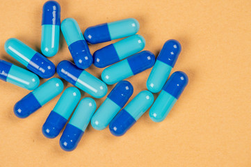 pill capsules and two shades of blue