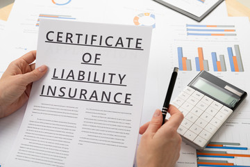 certificat of liability insurance concept, documents on the desktop