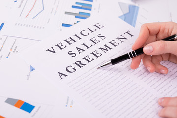 vehicle sales agreement concept, documents on the desktop