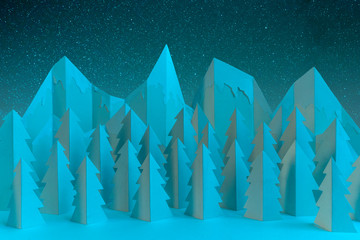 Winter paper landscape with mountains and pine trees at night - 303127651