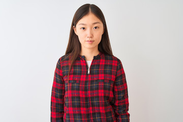 Fototapeta premium Young chinese woman wearing casual jacket standing over isolated white background Relaxed with serious expression on face. Simple and natural looking at the camera.