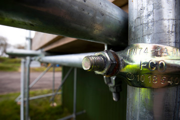 Galvanised steel scaffolding coupling connection on construction site 