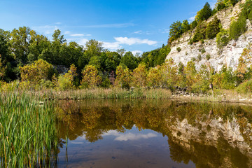 Fototapeta na wymiar rural landscape with rock cliffs reflected in a lake
