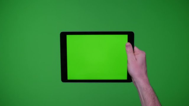 Hand gesture pack holding up ipad smart device on greenscreen