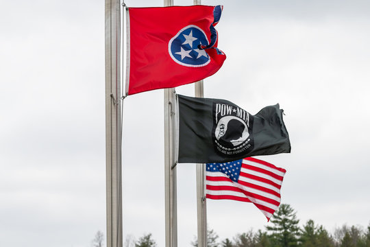 Walnut Hill, USA - April 19, 2018: Tennessee visitor's welcome center with row of state American and veteran flags waving in the wind