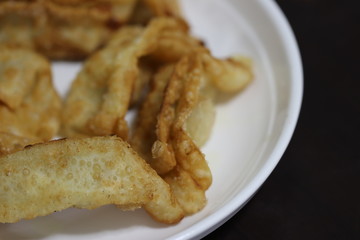 Freshly fried dumplings on a white plate. Selective and soft focus.
