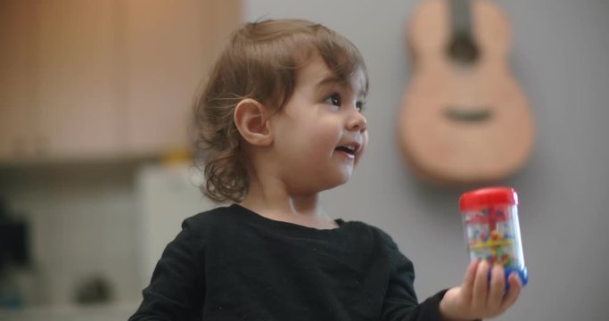 Cute 1-year old toddler girl at home. Shot in 4K RAW on a cinema camera.