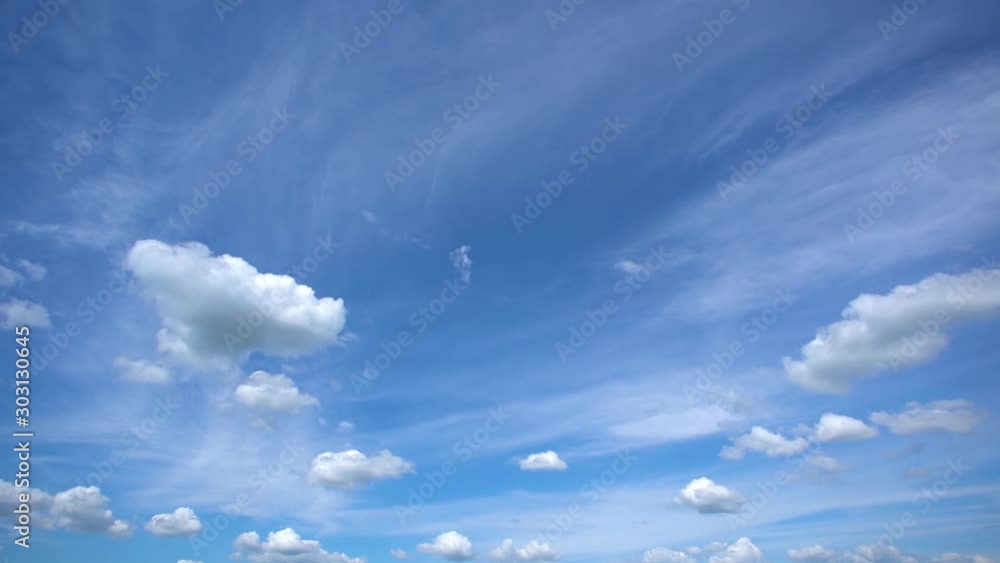 Wall mural amazing beautiful sunny soft white clouds running alone peaceful clear blue sky in evening. great na