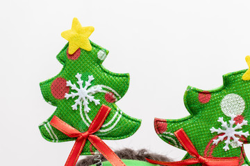 Textile green christmas tree wuth decorations on white background - xmas party concept