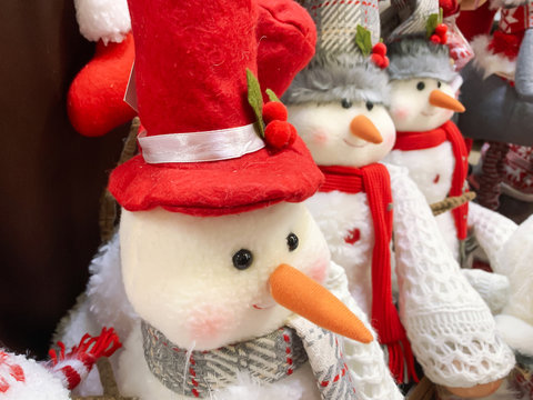 Decorative textule funny snowmen on a shelf at christmas market fair in mall