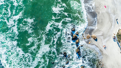 Vertical aerial top down view shot on people taking the last sunbathing. Odessa city beach, Odessa,...