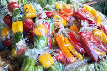 Fototapeta na wymiar Vegetables, bell​ pepper or paprika in a plastic bag​ at​ Hill​ tribe​ local​ market​ in​ Chiangdao, Chiangmai, Thailand.​ Save​ the​ world​ concept.