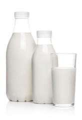 Bottles and glass containing milk drink, isolated on white background