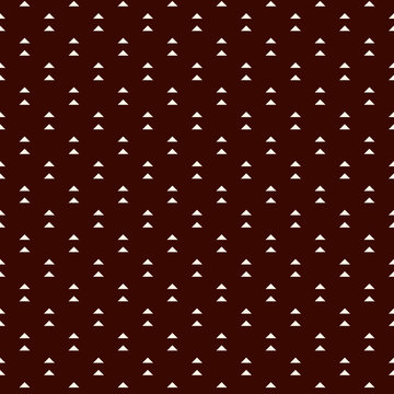 Fototapeta Repeated mini triangles on white background. Simple abstract wallpaper. Seamless pattern design with geometric figures.
