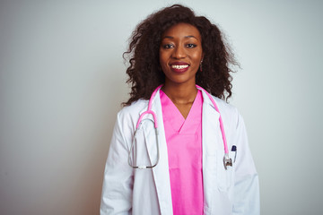 African american doctor woman wearing  pink stethoscope over isolated white background with a happy...