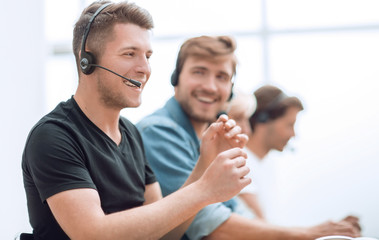 young call center employee sitting at his Desk.