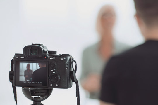 Background Image Is A Camera Filming An Interview In Studio