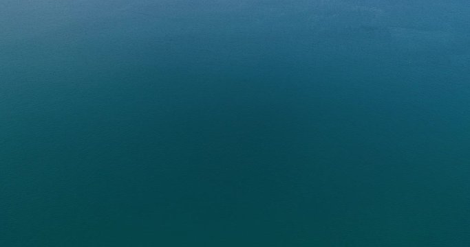 Aerial Drone flying flight over ocean tropical Sea in summer season with clouds and blue sky footage from drone aerial view Beautiful sea surface after camera tilt up