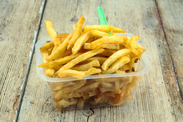 tray of french fries on a wooden table