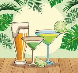 beer glass and tropical cocktails over tropical leaves and retro style background
