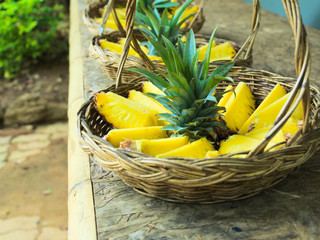 Fresh, juicy, pineapple sliced and laid out in a basket