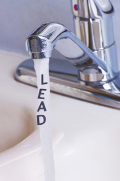 Lead in City tap water, actual lettering LEAD coming out of a stream of water from the kitchen faucet