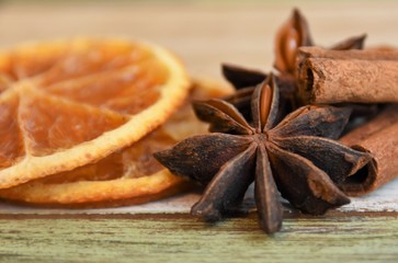 dried slices of orange, cinnamon rolls and anise
