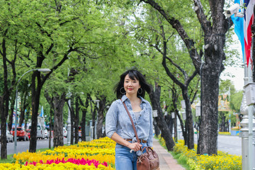 Thai woman wearing a T-shirt and jeans. Are happy in public park Bangkok Thailand