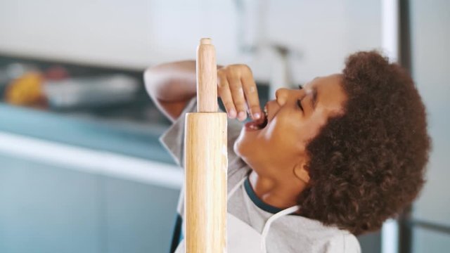 Young family cooking food in kitchen. Happy Little girl with her mother mixing batter. Mother and Little boy preparing the dough. Happy family in the kitchen and junior chef Concept. Cinematic 4k.