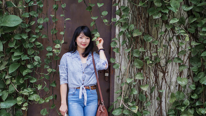 Thai woman wearing a T-shirt and jeans. Are happy in public park Bangkok Thailand