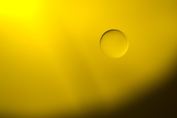 Yellow cooking Oil bubble and drops on water for background.