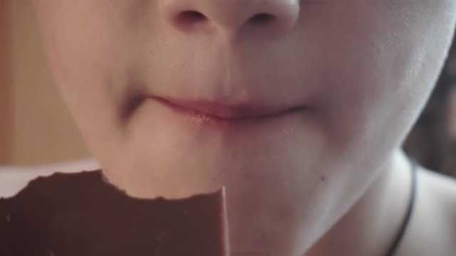 boy eating chocolate.children's mouth closeup