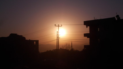 Fototapeta na wymiar A sunrise scenery captured with buildings as silhouettes around.