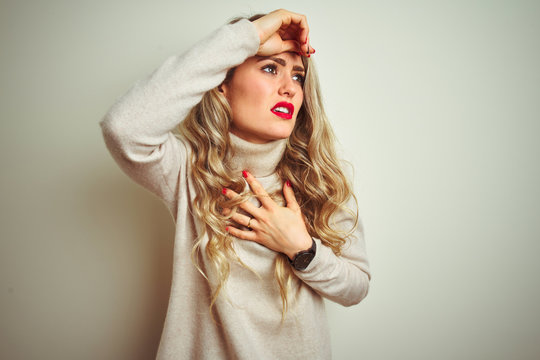 Beautiful woman wearing winter turtleneck sweater over isolated white background Touching forehead for illness and fever, flu and cold, virus sick