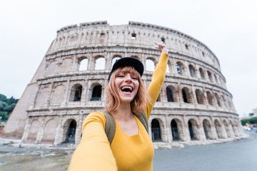 Plakat Happy beautiful young woman take a selfie at the Colosseum in Rome, Italy.