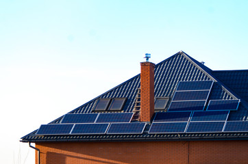 Roof of the house with solar panels, expensive and elite area and clear sky
