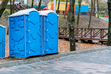 Portable WC in the park. Outdoor transportable toilet in the city's park. Urban. Restroom. Sanitary...
