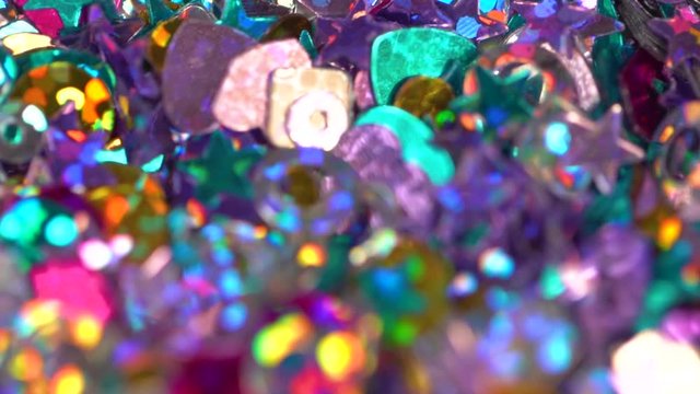 Closeup view of beautiful shiny sparkling particles. Bright holiday colorful video background.