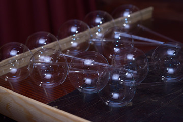 Glassblowing. Blanks of Christmas decorations, balls, placed on a work table of a glassblower