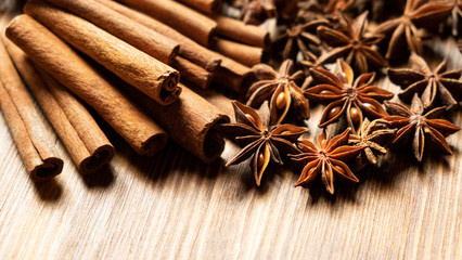 Star anise, cinnamon. Aromatic spices on wooden background. Top view. Close up. Seasoning ingredients for cooking or baking