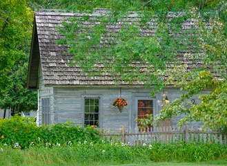 Rustic country home with trees in the summer