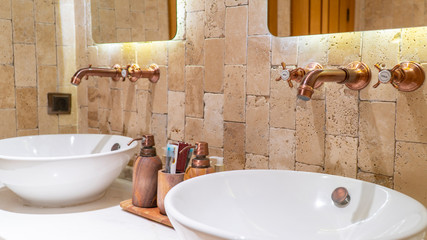 modern cafe toilet.brick walls with retro valve and mirror