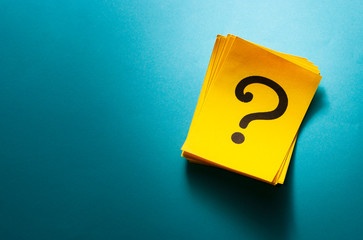 Stack of colorful yellow cards with question mark