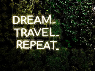 "Dream, Travel, Repeat" quote - Neon cool inspiring quote about travel and dreams